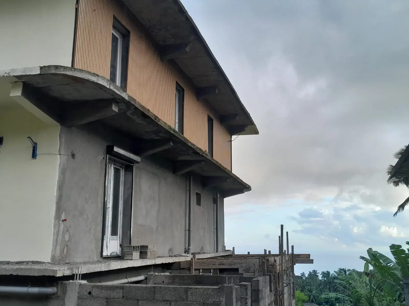Muret de jardin habillé du même bardage bois clair-voie que la façade.